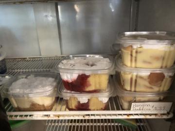 Displayed left to right regular cheesecake, strawberry shortcake, and banana pudding